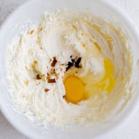 egg, vanilla extract, and creamed butter in a white bowl