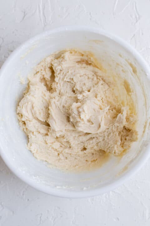 raspberry thumbprint cookie dough formed in a white bowl