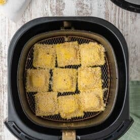 panko-coated ravioli inside an air fryer basket