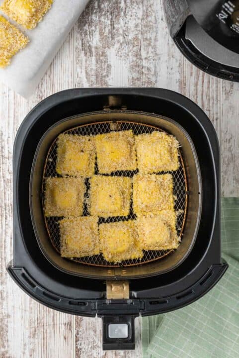 panko-coated ravioli inside an air fryer basket