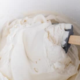 heavy cream mixture being mixed together with a silicone spatula
