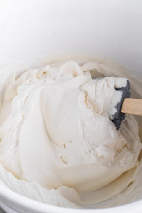 heavy cream mixture being mixed together with a silicone spatula