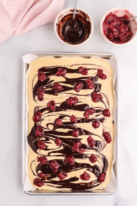 tart cherries dotted across the top of the pancake batter and chocolate sauce