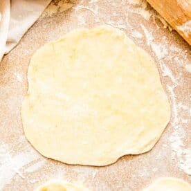 dough is rolled out into a 6 inch diameter next to a rolling pin