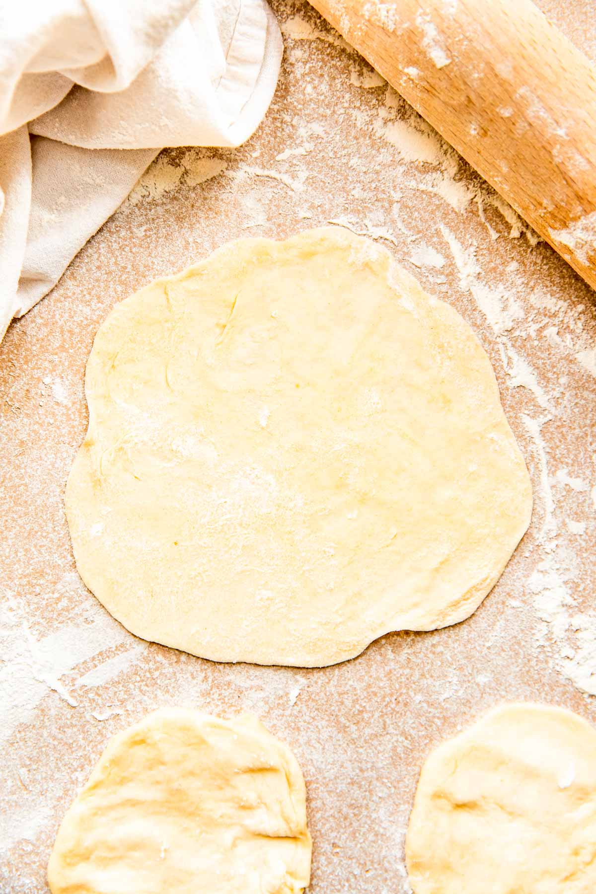 dough is rolled out into a 6 inch diameter next to a rolling pin