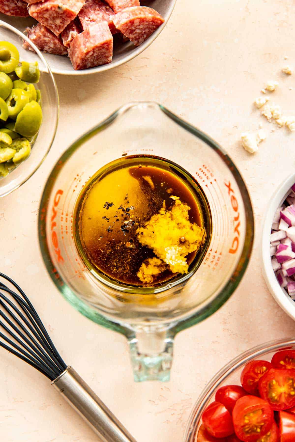 olive oil, balsamic vinegar, garlic, and seasonings in a glass measuring cup