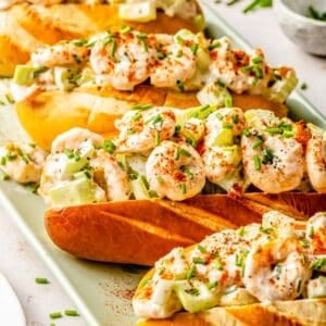 shrimp rolls in a diagonal line on a green plate
