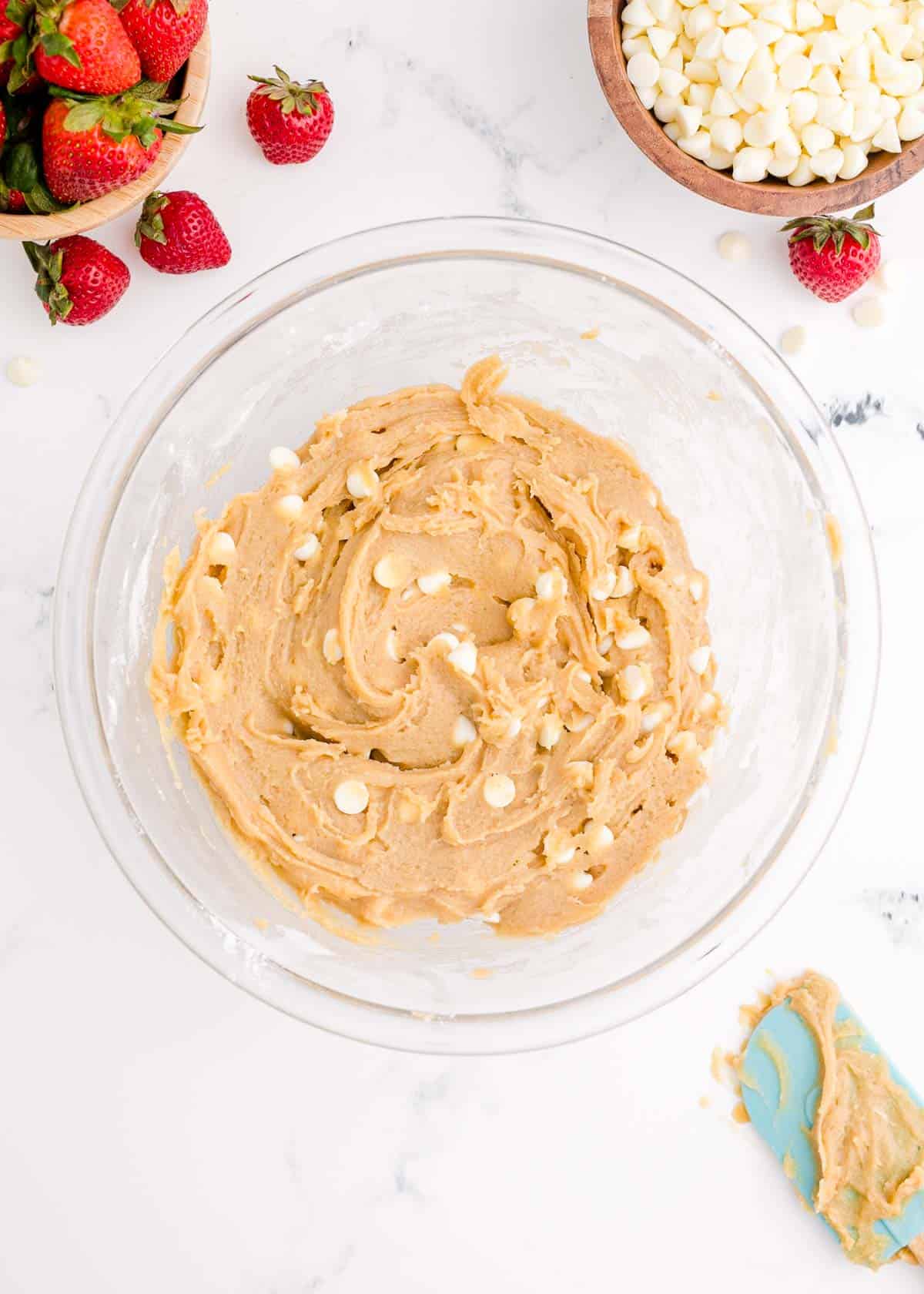 white chocolate chips mixed into a clear white bowl