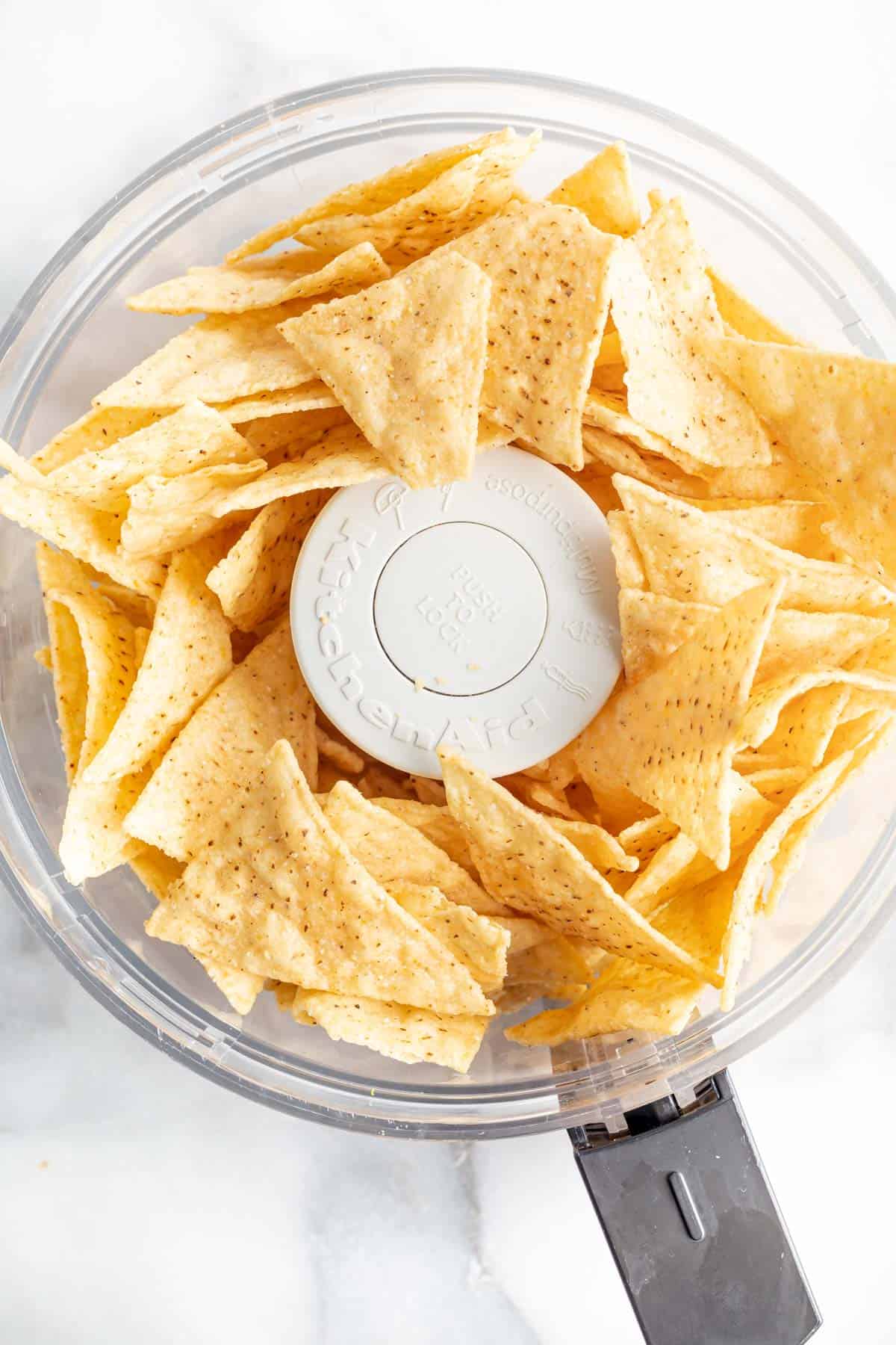 tortilla chips in the bowl of a food processor