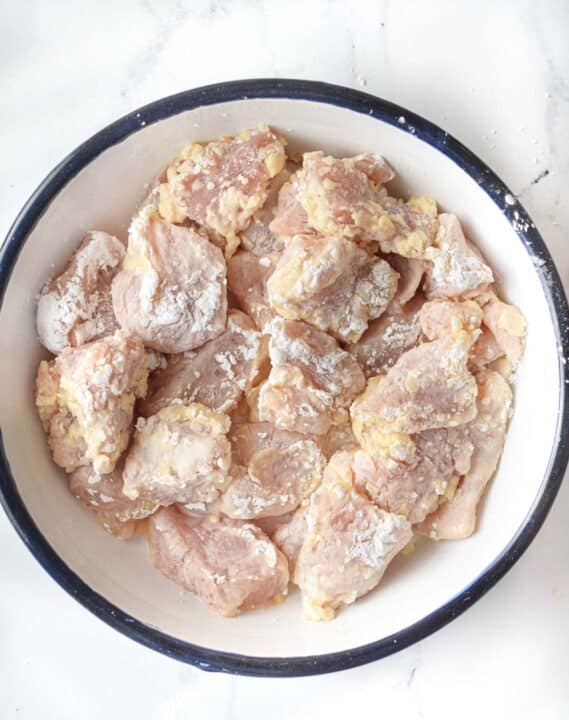 chicken thigh pieces coated in egg and cornstarch