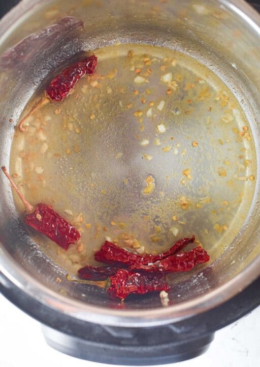 garlic, ginger, and red pepper cooking in the instant pot