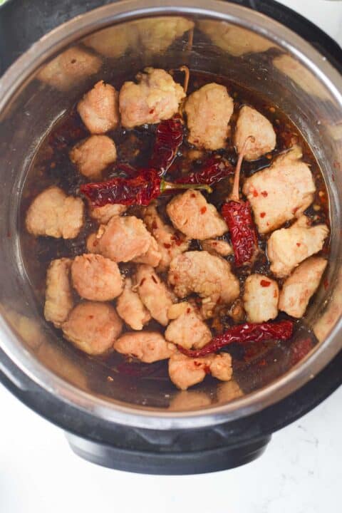 chicken added to the sauce in the insert of an instant pot