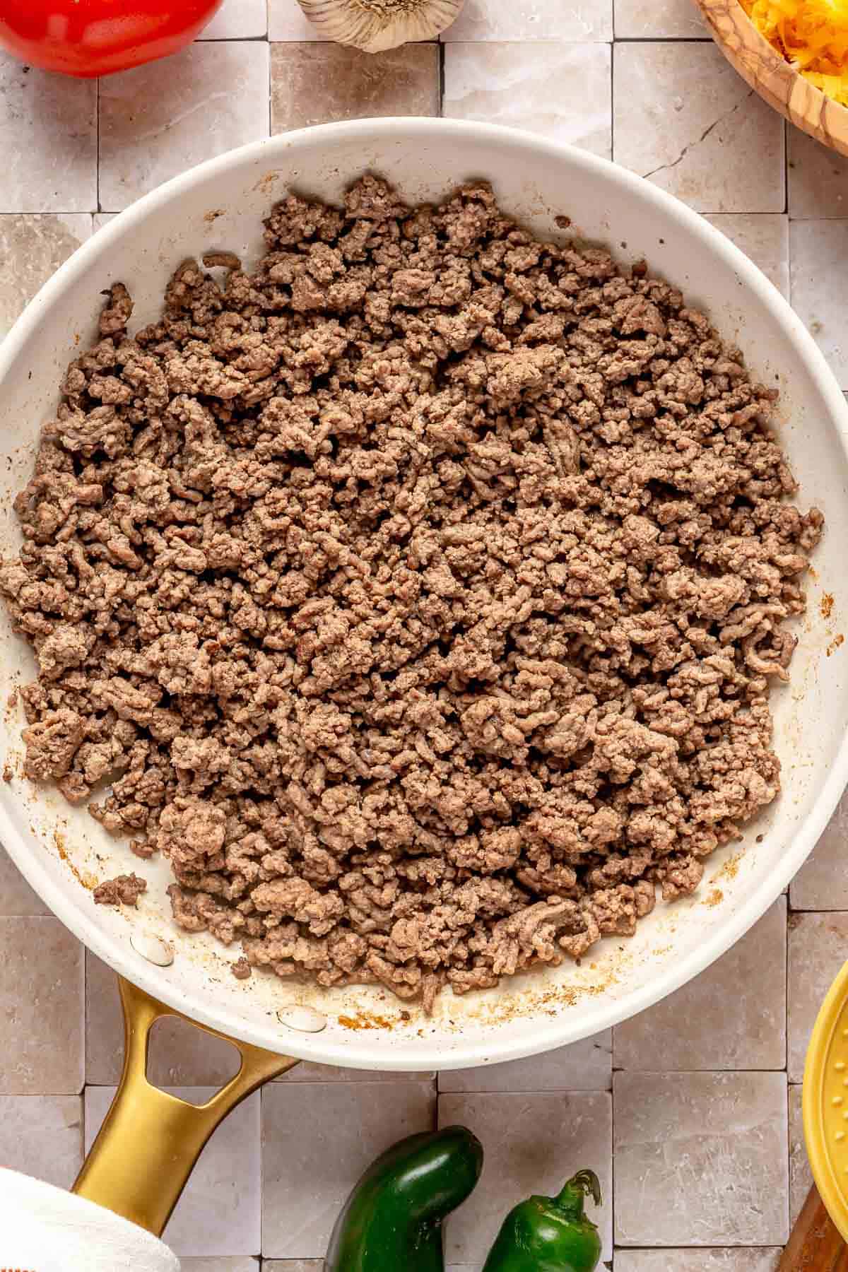 browned ground beef in a white nonstick skillet