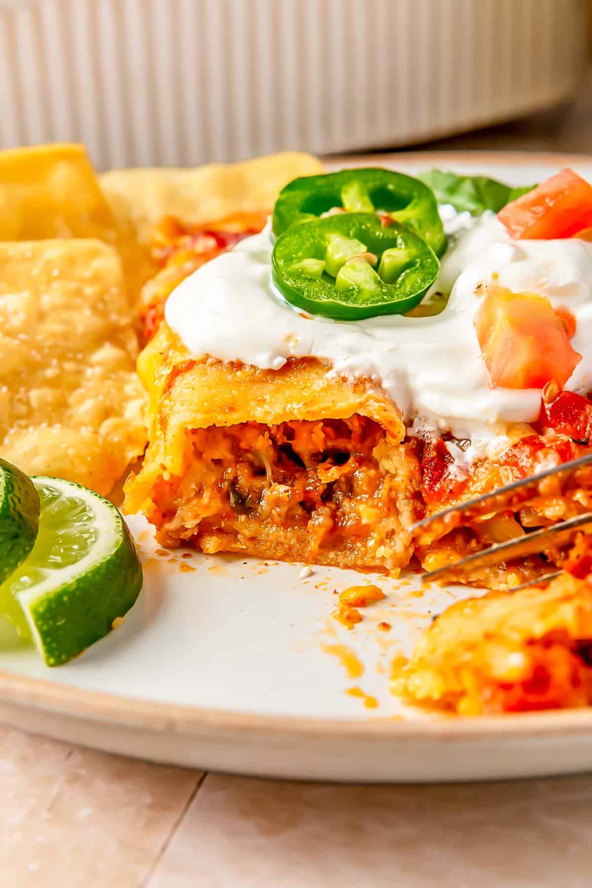 a beef enchilada has been sliced into to reveal the insides