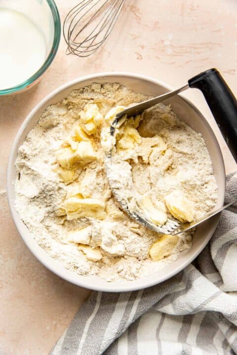 butter being cut into flour with a pastry cutter