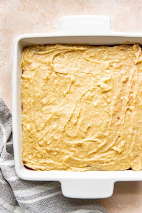 cobbler topping spread in an even layer in a square baking dish