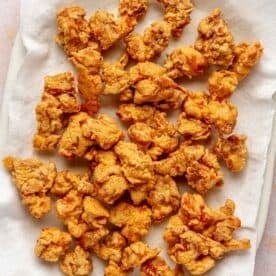 deep fried chicken pieces on a paper towel-lined plate