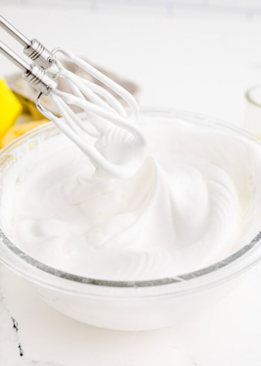 meringue topping is being whisked together with an electric whisk