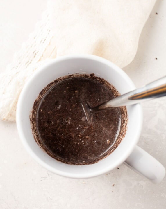 oreo mug cake batter in a white mug