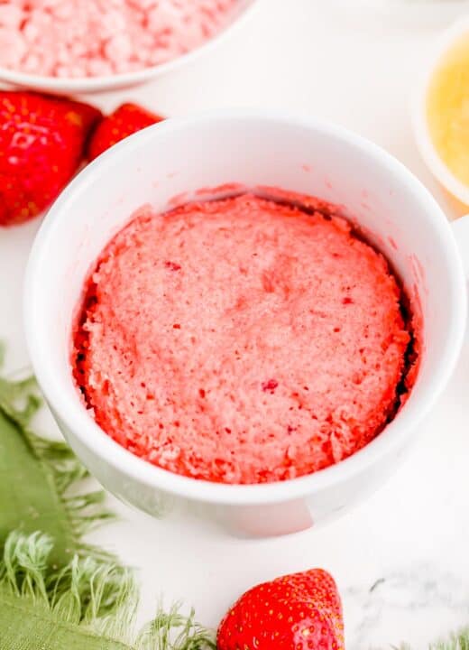 cooked strawberry mug cake in a white mug