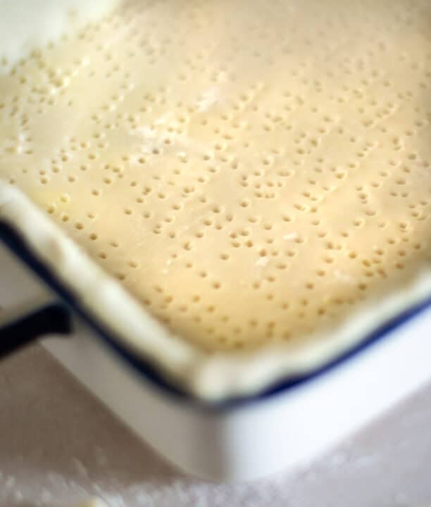 holes poked throughout dough in bottom of baking dish