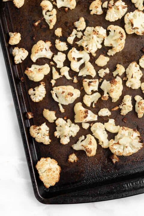 roasted cauliflower on a metal baking pan