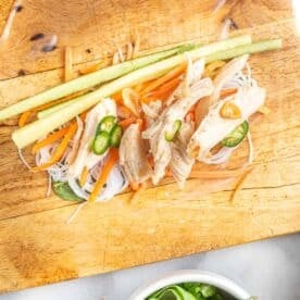 ingredients for chicken summer rolls on top of softened rice paper wrap