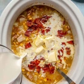 butter and half and half being added to the insert of the slow cooker