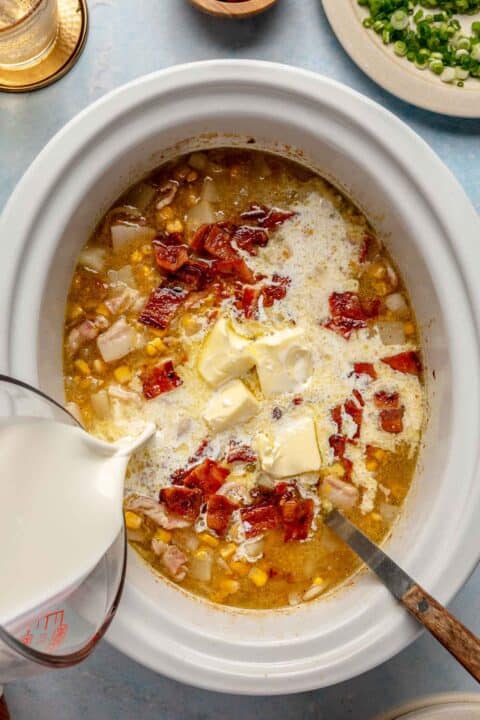 butter and half and half being added to the insert of the slow cooker