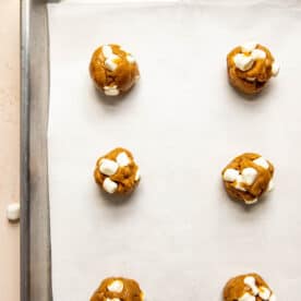 marshmallow studded cookie dough balls on parchment paper