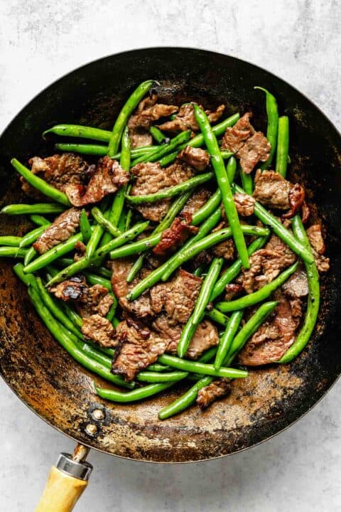 green beef and flank steak in a wok
