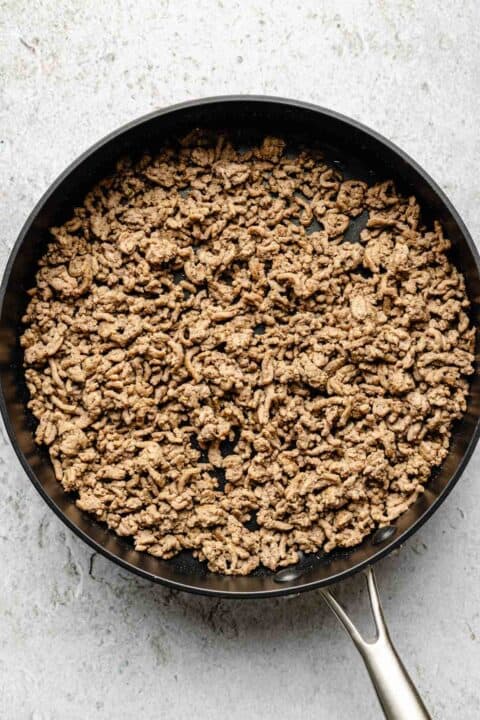 ground beef broken into smaller pieces in a nonstick skillet