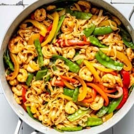 stir fry sauce added to and tossed with rice noodles, shrimp, and vegetables