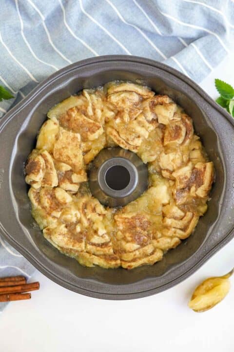 cinnamon rolls and apple pie filling added to a nonstick bundt pan