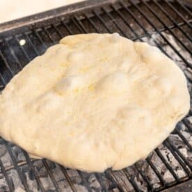 pizza dough on top of an outdoor grill