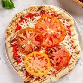 sliced heirloom tomatoes on top of mozzarella cheese