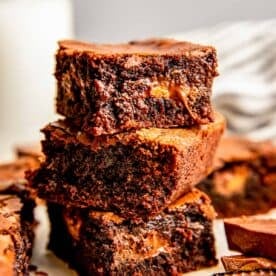three reese's cup brownies are stacked on top of one another with a gooey peanut butter center displayed